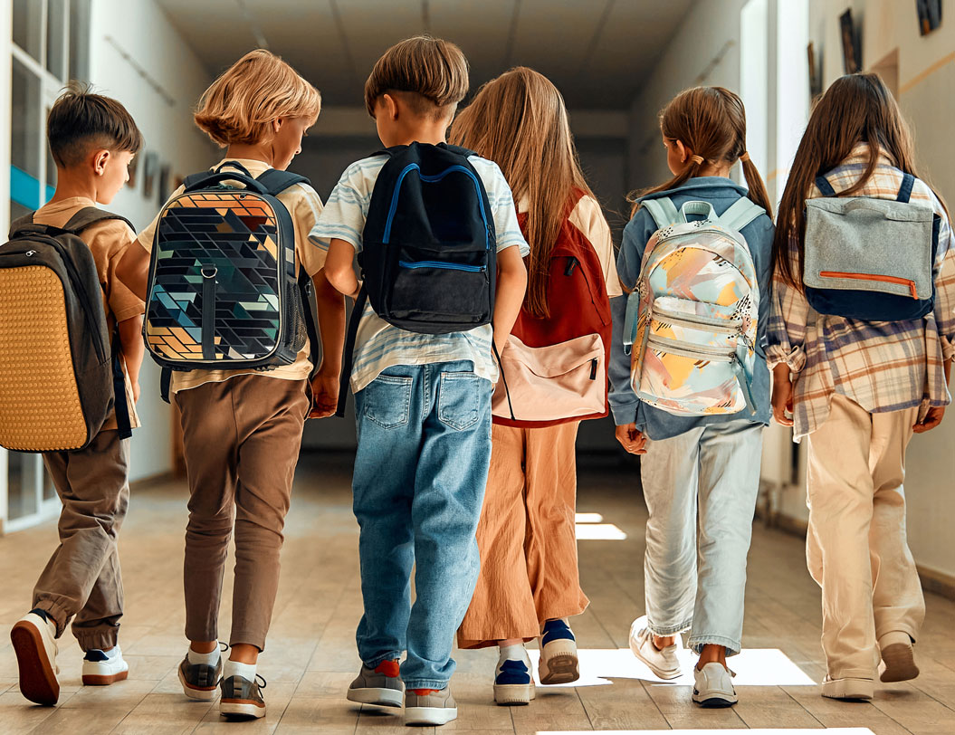 Young students walking down school hallway