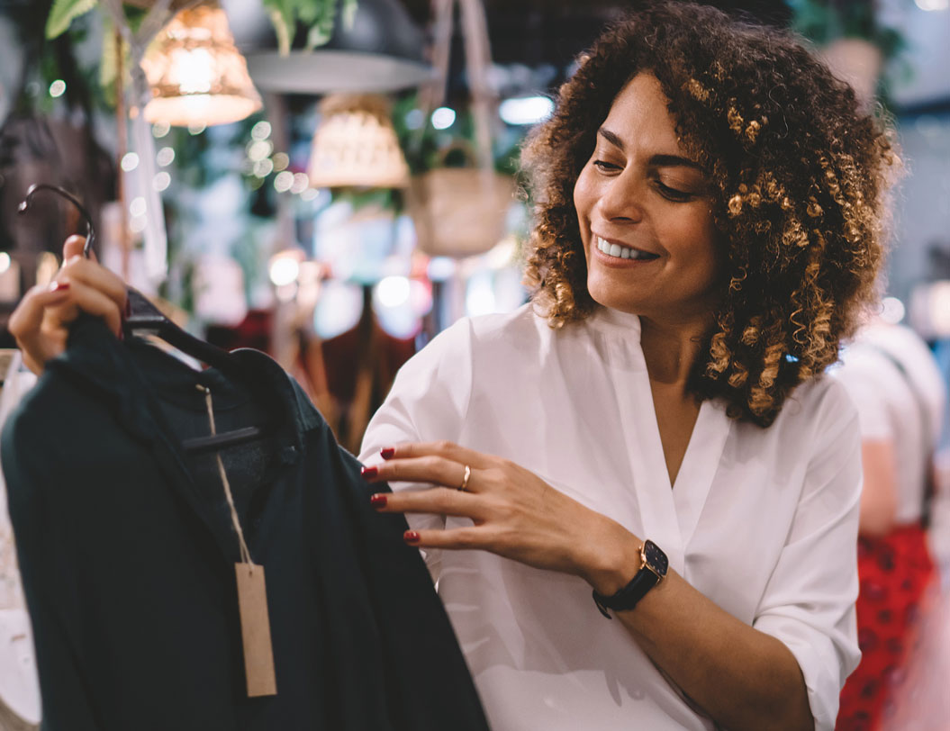 Woman looking at a jacket while shopping