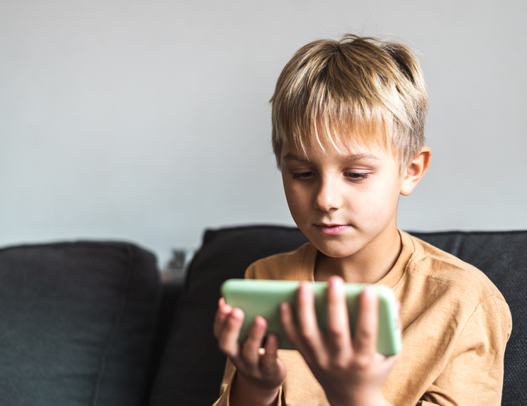 Young boy holding a phone