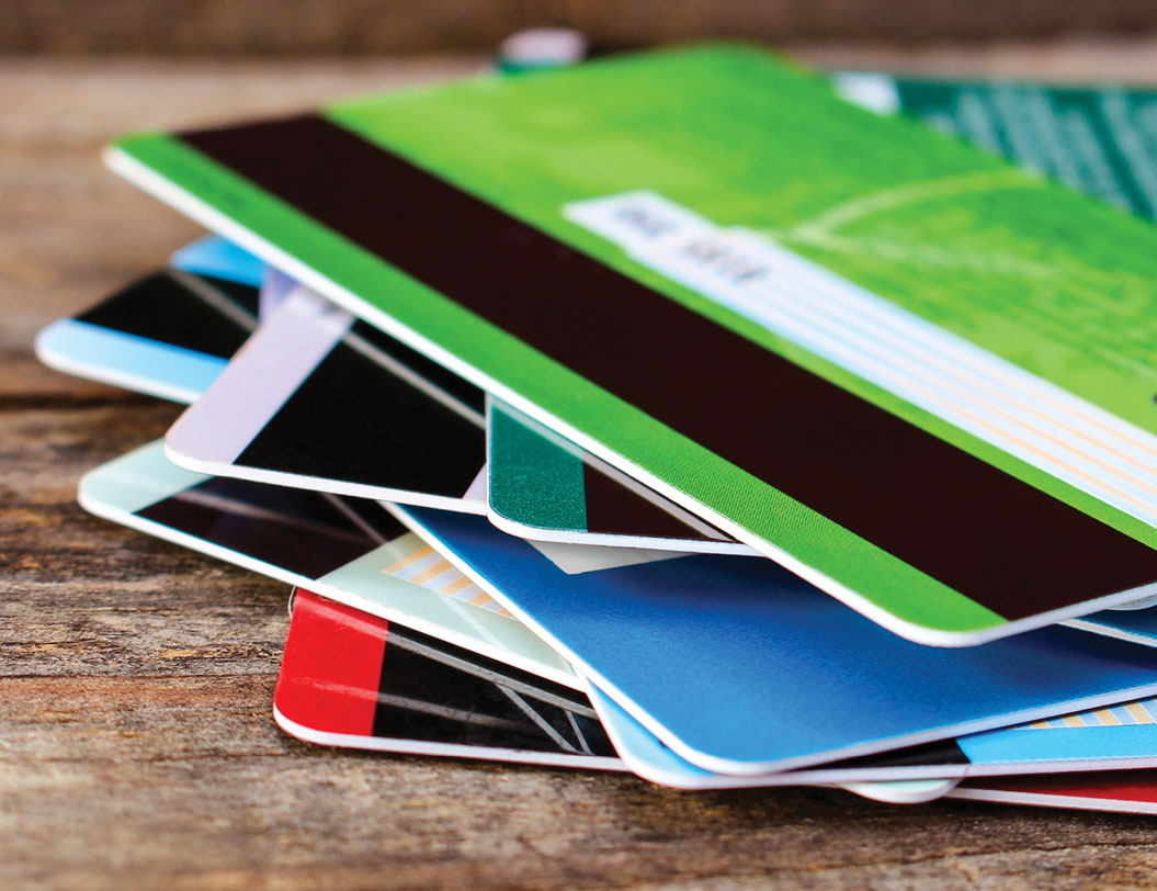 stack of credit cards on wood table