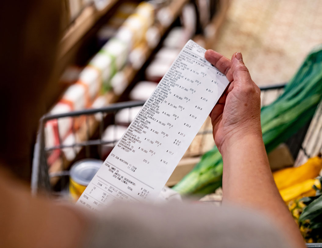 Woman reviewing shopping receipt