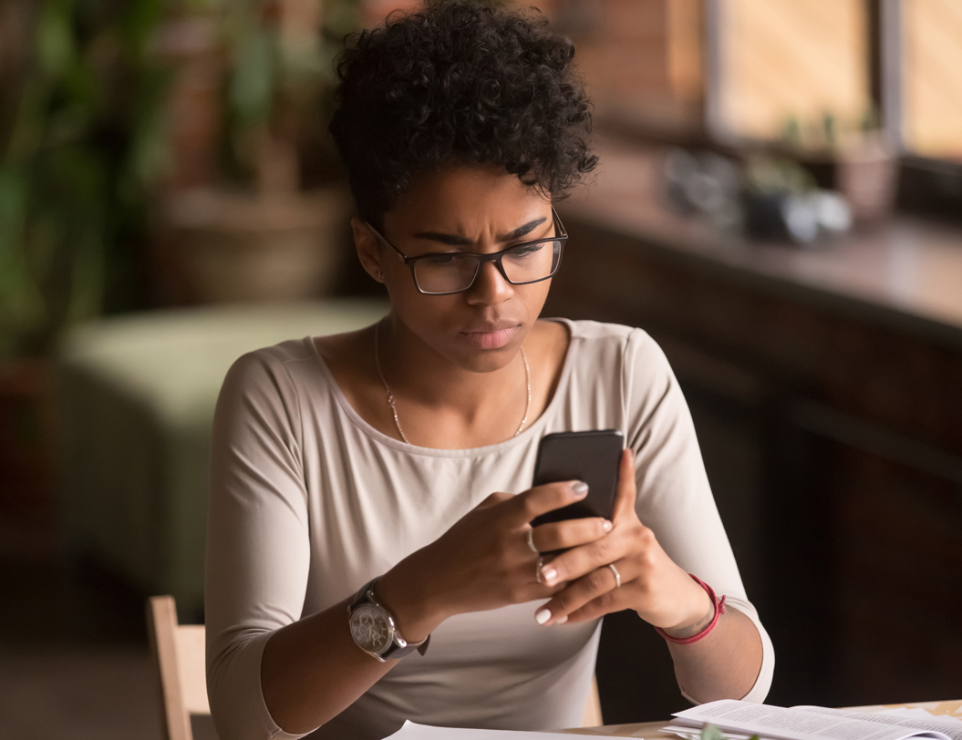 Woman on cell phone with concerned expression