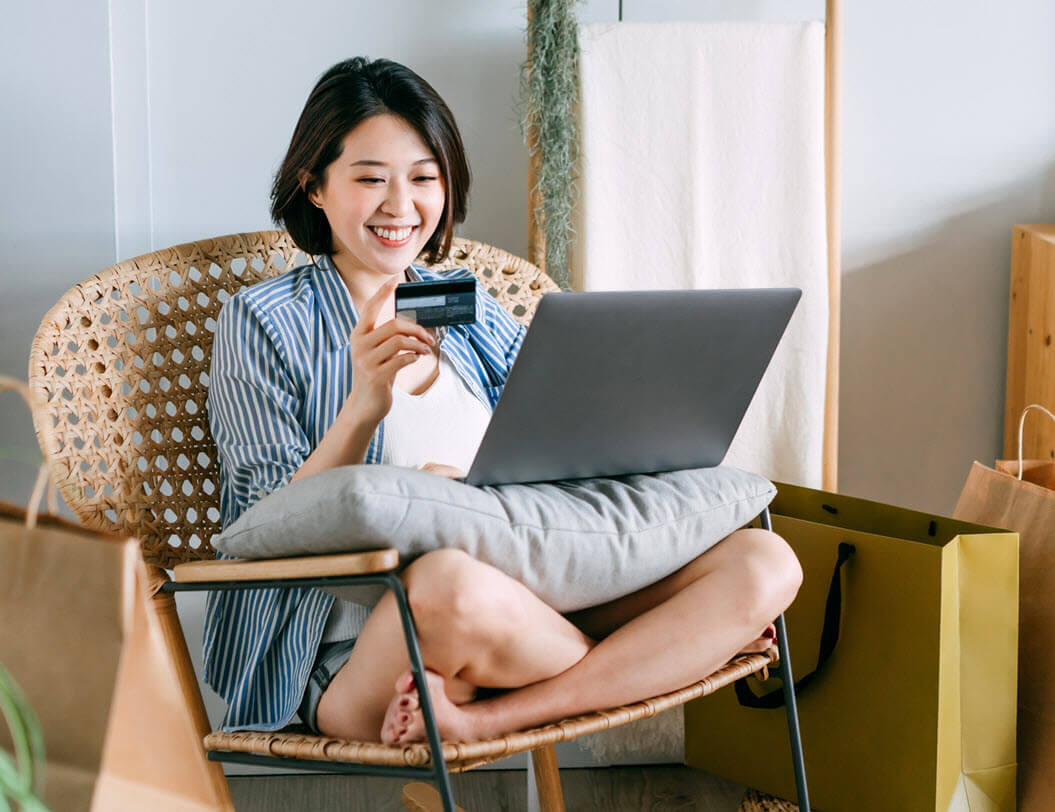 Girl shopping online with credit card and laptop